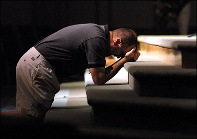 Jason Young of Klamath Falls, Ore. prays at Bible Baptist Church Tuesday night, during a prayer meeting held at the church